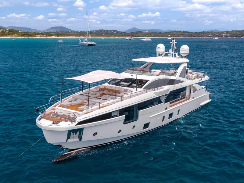 NEMESIS motor yacht anchored in blue water showing the foredeck sunshade and upper deck structures.