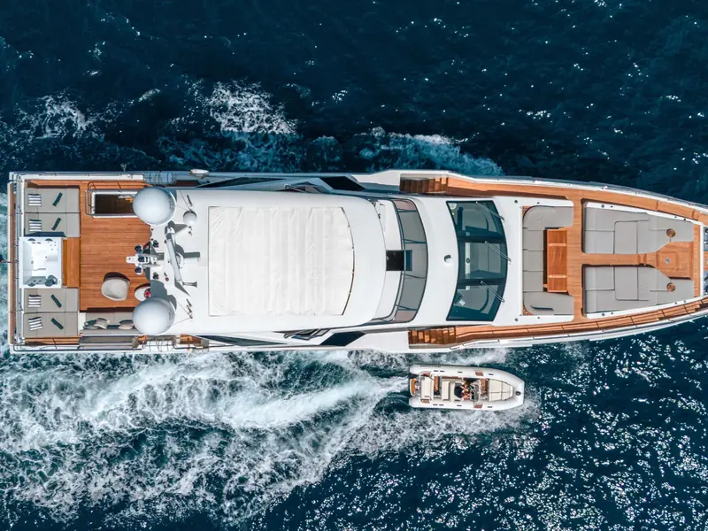 NEMESIS yacht from a top-down aerial view cruising with a tender alongside.