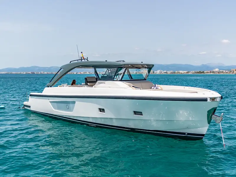 Yacht EXPERIENCE, a Bluegame 54, anchored in calm turquoise water with a white hull and grey hardtop.