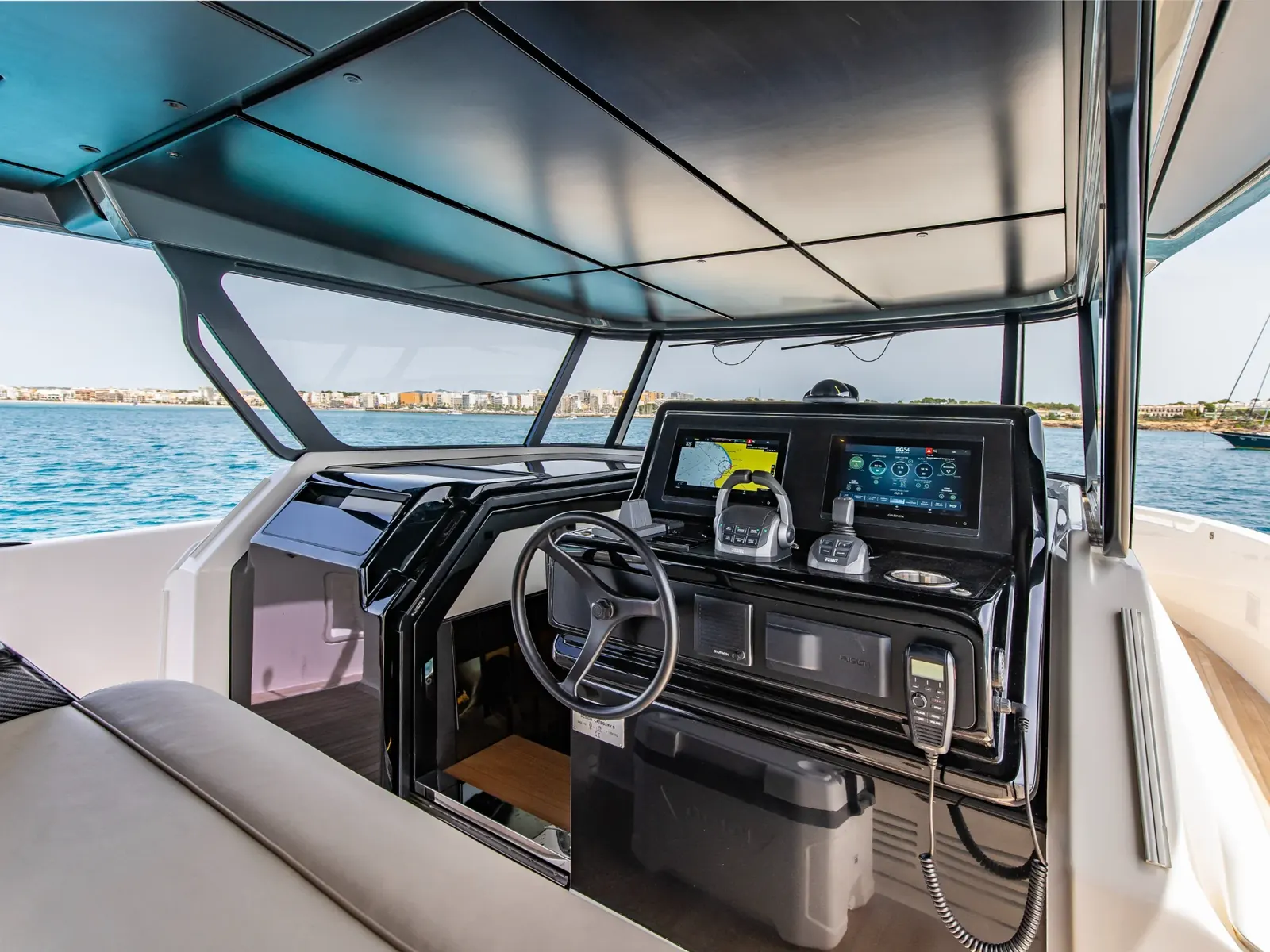 LIQUID SPIRIT helm station featuring Garmin displays, Volvo Penta controls, and a black steering wheel.