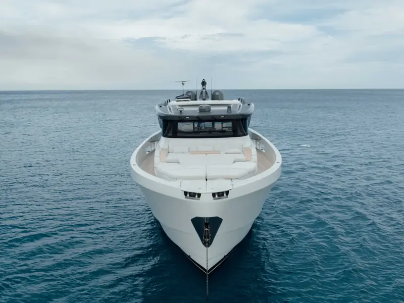 PETITCHET II motor yacht seen from the bow at sea, showing the foredeck sunpads and anchor chain.