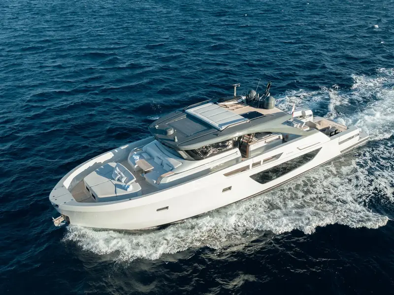 PETITCHET II yacht cruising at speed on the open sea, showing the foredeck sunpads and hardtop.