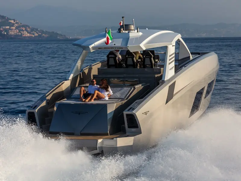 Yacht NEXT cruising at speed with passengers on the aft sunpad and a view of the hardtop and radar.