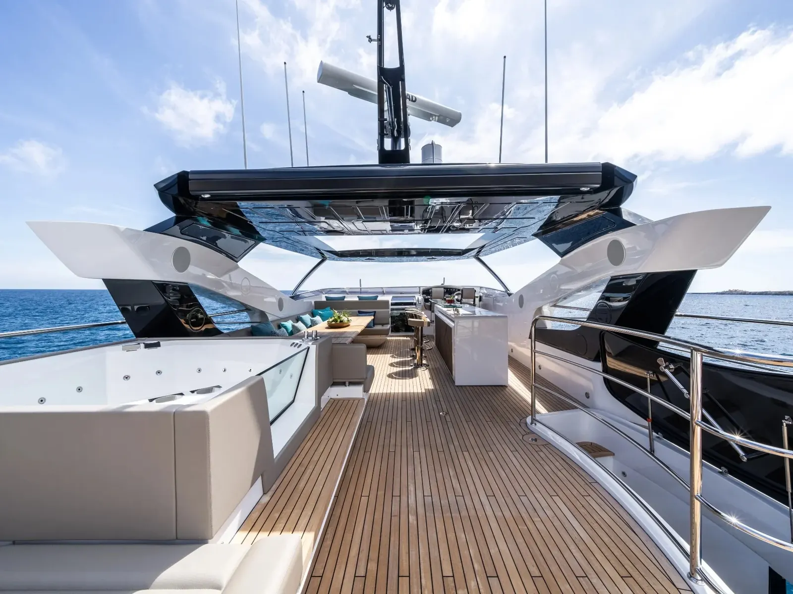BLUE INFINITY ONE flybridge featuring a hot tub, teak decking, and a hardtop with integrated radar mast.
