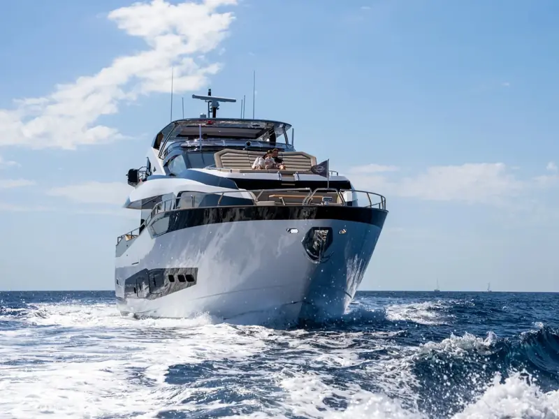 BLUE INFINITY ONE cruising on the open sea, viewed from a low angle at the bow.