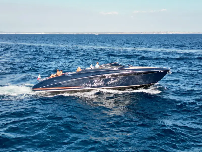 JAD & JULIA Riva 44 Rivarama cruising on the open sea with people visible on deck.
