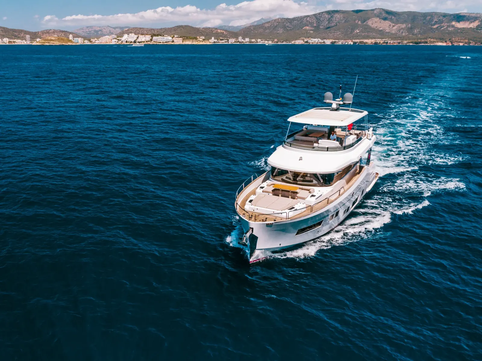 SALACIA yacht cruising at sea, showing the bow, foredeck seating, and flybridge with a hardtop.
