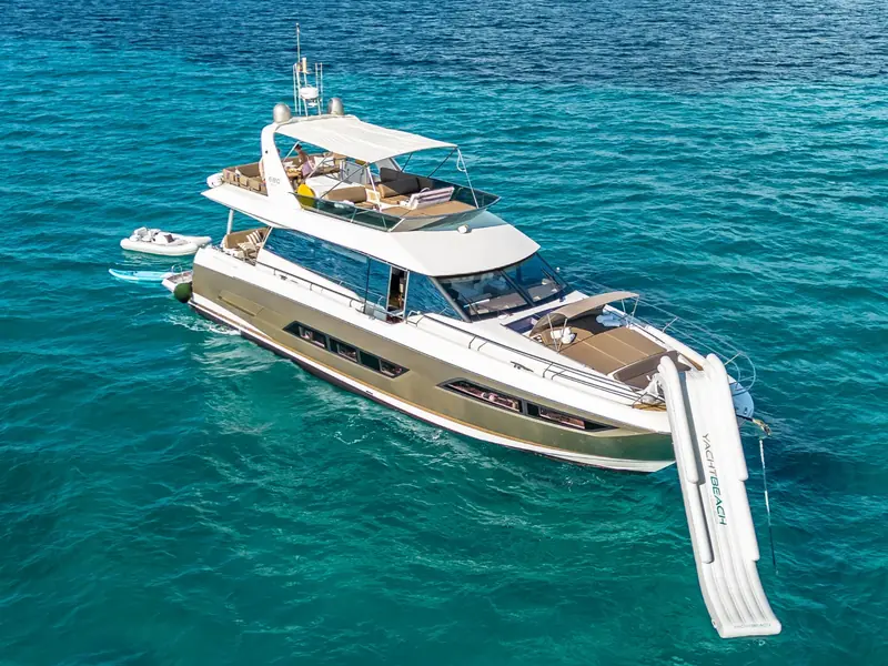 Aerial view of BLUE M, a Prestige 680 yacht anchored with an inflatable slide and tender deployed.