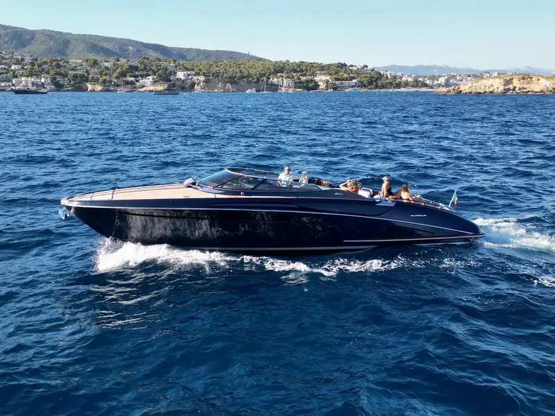 JAD & JULIA, a Riva 44 Rivarama motor yacht, cruising on blue water with passengers on deck.