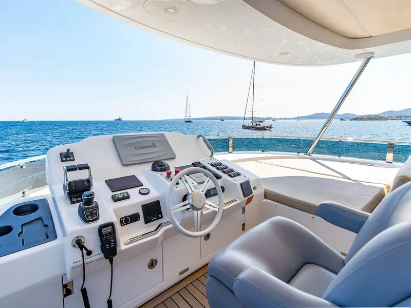 SALACIA yacht flybridge helm station with Garmin display, joystick controls, and white steering wheel.
