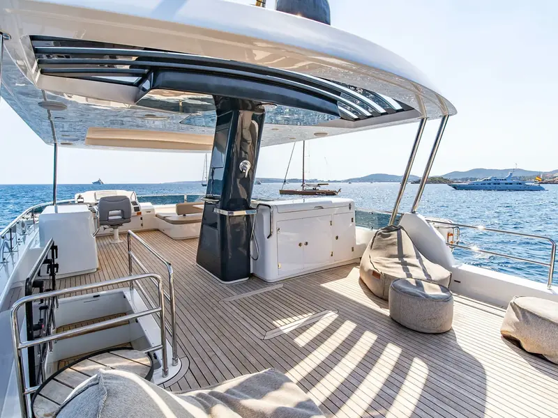 SALACIA yacht flybridge featuring teak decking, a wet bar, bean bag seating, and a hardtop sunroof.