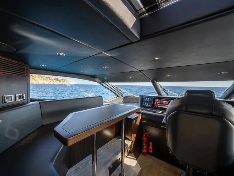 BLUE INFINITY ONE helm station view through the windscreen showing digital displays and a leather pilot seat.