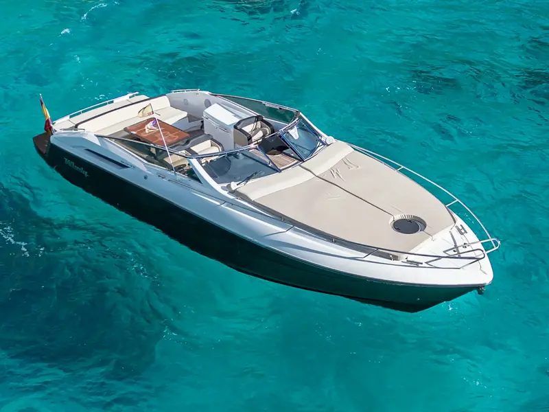 High angle view of yacht CUCA showing the foredeck sunpad and cockpit area in clear turquoise water.